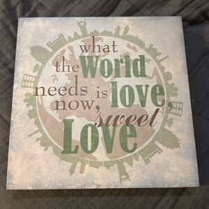 “What the world needs now” wall sign